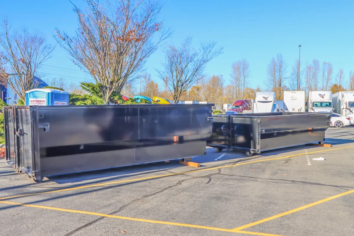 Professional dumpster rental service with roll-off container on residential driveway in Fallston